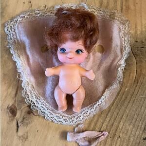 Vintage Small Bottle Baby Doll. 2in. with wrap/robe. Blue eyes. red hair.